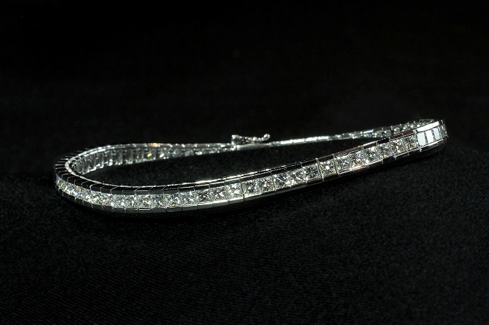 Channel style tennis bracelet with princess cut diamonds