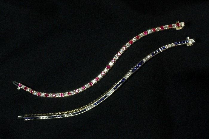 Two tennis bracelets, one alternating round cut rubies and diamonds in prong settings, one with square blue sapphires and round cut diamonds