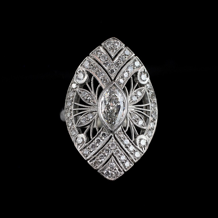 Vintage style ring with marquise cut center diamond surrounded by round cut diamonds