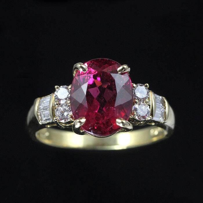 Oval red tourmaline ring with round and baguette cut diamonds