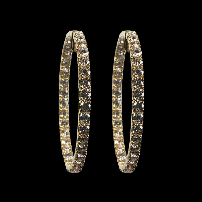 Inside-out hoop earrings in yellow gold with round cut diamonds
