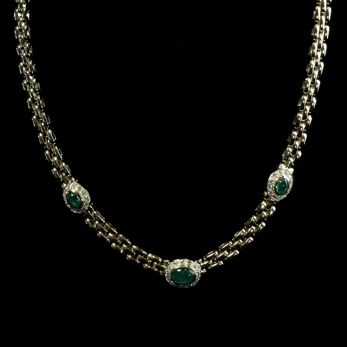 Three row gold necklace with cabochon shape emeralds surrounded by round cut diamonds