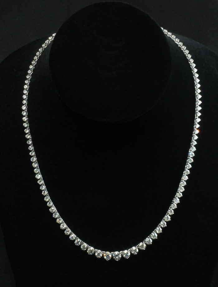 Tennis style necklace with round cut diamonds in three prong settings